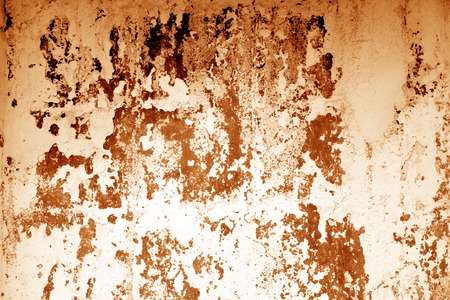 Ñraked weathered cement wall texture in orange tone. Abstract background and texture for design.の写真素材