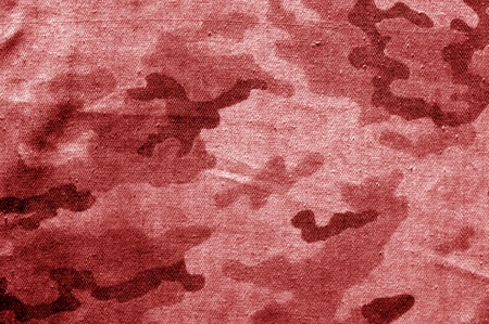 Dirty camouflage cloth in red tone. Abstract background and texture for design abd ideas.の写真素材