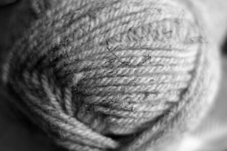 Yarn ball close-up with blur effect in black and white. Abstract background and texture for design.の写真素材