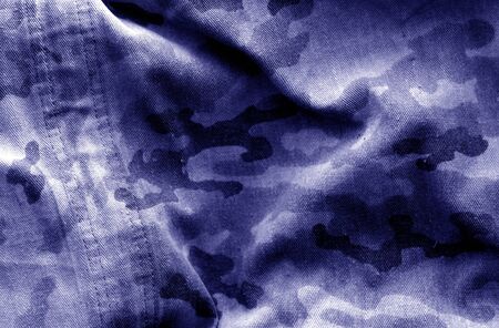 Dirty camouflage cloth with blur effect in blue tone. Abstract background and texture for design abd ideas.の写真素材