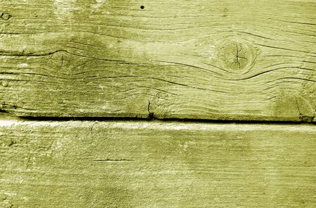 Weathered wooden painted wall in yellow color. Abstract background and texture for design.の写真素材