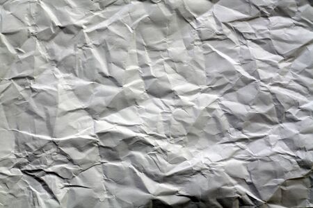 Crumpled sheet of paper with blur effect. Abstract background and texture for design.の写真素材