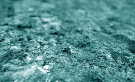 Old stone surface with blur effect in cyan tone. Abstract architectural background and texture for design.の写真素材
