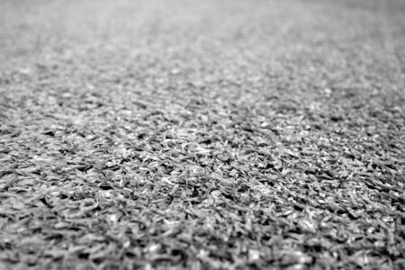Artificial grass with blur effect in black and white. Abstract background and texture for design.の写真素材