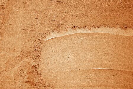 Grungy cement wall texture in orange color. Abstract background and pattern for design.