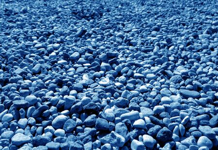 Pile of small gravel stones in navy blue tone. Seasonal natural background.の写真素材