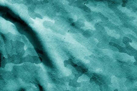 Old military uniform pattern in cyan tone. Abstract background and texture.の写真素材