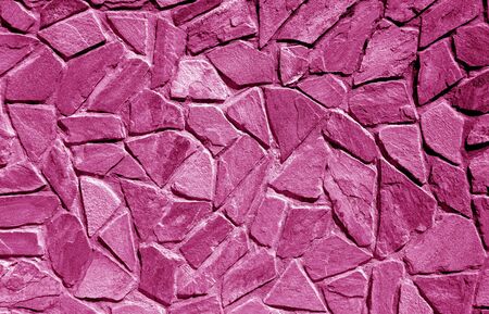 Wall made of old stones in pink tone. Abstract background and texture for design.の写真素材