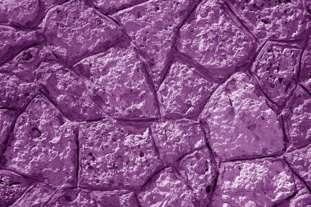 Wall made of old stones in purple tone. Abstract background and texture for design.の写真素材