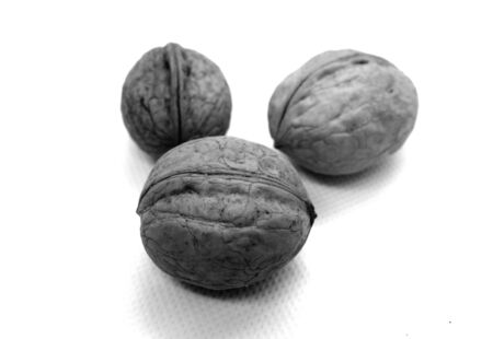 Three wallnuts on white in black and white. Food and ingredients background.の写真素材