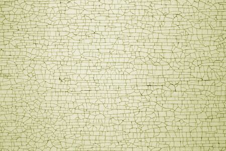 Cracks on metal texture in yellow tone. Abstract background and texture for design.