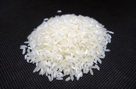 White rice isolated on black. Food and ingredients background.の写真素材