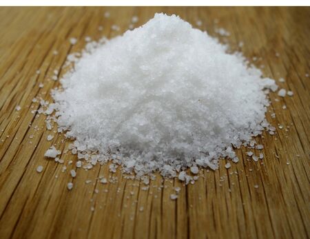 Sea salt on wooden board. Food and ingredientes background.