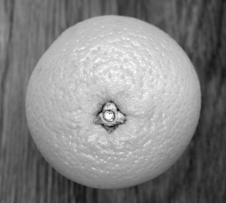 Mandarin orange on wooden board in black and white. Food and ingredients background.の写真素材