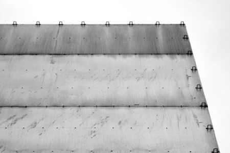 Old empty bill board in in black and white in front of cloudy sky. Background and advertizing.の写真素材