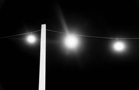 Electric lights at night in black and white. Abstract scene and bacground               の写真素材
