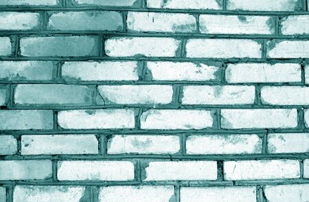 Old grungy brick wall texture in cyan tone. Abstract architectural background and texture for...