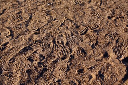 A lot of foot steps on sand road. Seasonal background for wallpaper or design.の写真素材