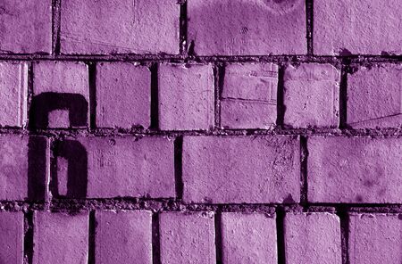 Number 6 in stencil on rusty brick wall in purple tone. Abstract background and texture for design.の写真素材