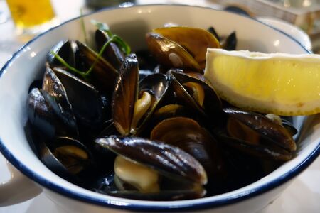 Serving of cooked mussels. Food and ingredients background.