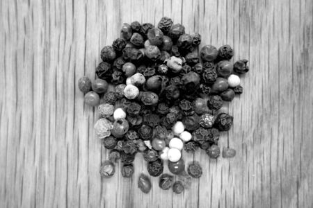 Mix of color pappers on wooden board with blur effect in black and white. Food and ingredients background with blur effect.の写真素材