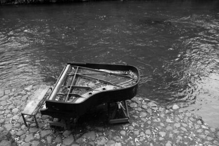 Broken piano on river bank in Vilnius. Urban backgroundの写真素材