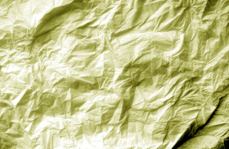 Crumpled white paper background in yellow tone. Abstract architectural background and texture for design.の写真素材