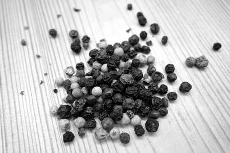 Mix of color pappers on wooden board in black and white. Food and ingredients background with blur effect.の写真素材