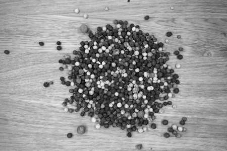 Mix of color pappers on wooden board in black and white. Food and ingredients background with blur...