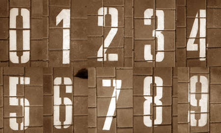 Numbers from zero to nine on pavement in brown tone. Abstract background and texture for design.の写真素材