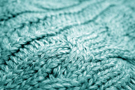 Warm knitting texture with blur effect in cyan tone. background and texture for design.