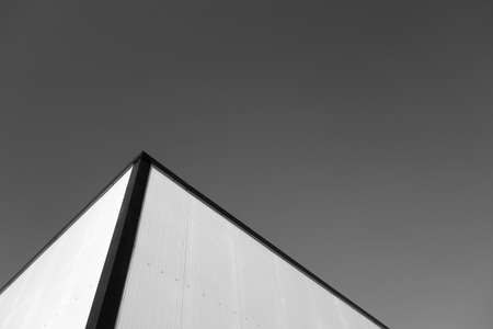 Commercial warehouse aluminum wall and roof against sky. architectural backgroundの写真素材