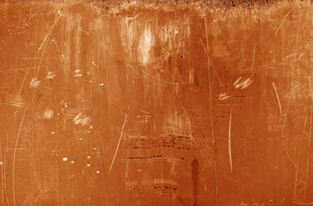 Grungy rusted metal wall surface in orange tone. Abstract background and texture.の写真素材