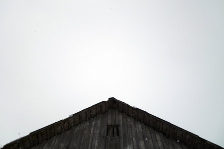 Old wooden roof top against foggy sky. Architectural backgroundの写真素材