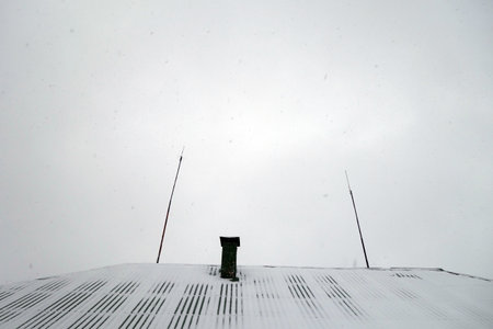 House roof with chimney covered with snow. Architectural backgroundの写真素材