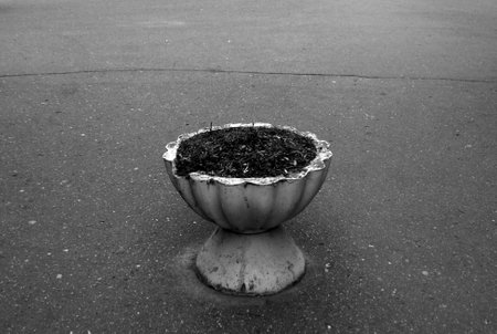 Old damaged cement street vase without flowers. Architectural detail. Black and white style.の写真素材