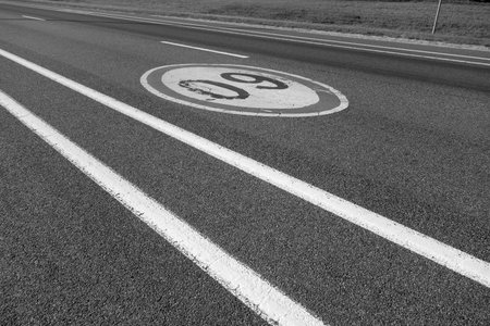 Sixty speed limit sign on asphalt road. Traffic signs and symbols background.の写真素材