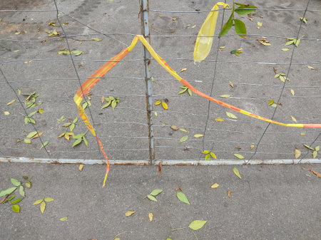 Metal grid fence on the territory of construction and reparation works. Urban industrial scene and viewの写真素材