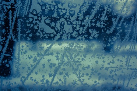 beautiful frozen snowflakes on a window cold lookの写真素材