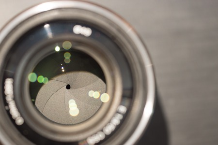 closeup macro of camera lense with reflections low key sepia effect image with aperture bladesの写真素材