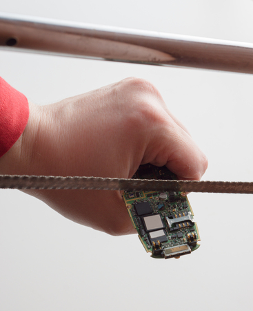trying to repair cellphone with handsaw by cutting into pieces. wrong tools fun concept