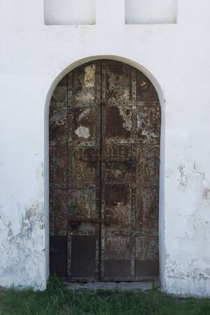 ancient rusty metal door entrance to old medieval castleの写真素材