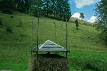 haystack under the hay shed at the mountain green hillsの写真素材