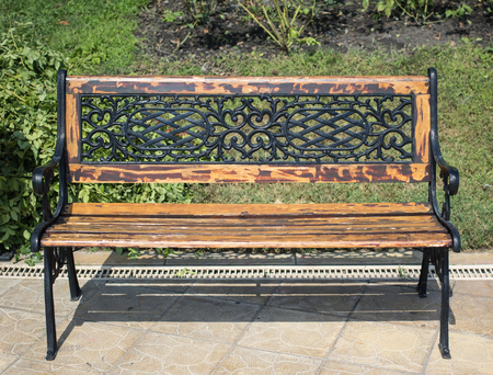 modern wooden benches in the summer garden in a sunny day