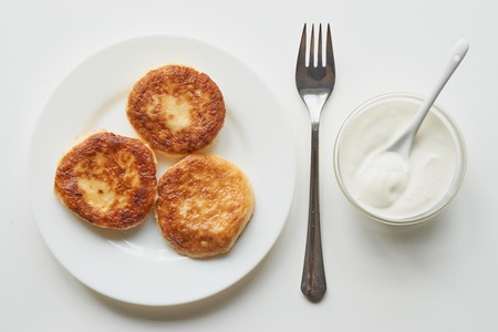 tasty healthy breakfast three pancakes on white plate isolated. top shot view on white tableの写真素材