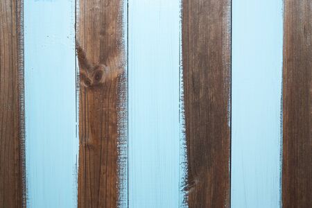 dark wooden planks with zebra stripped light blue sloppily painting for creative backgroundの写真素材