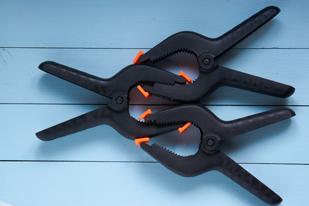 concept image show unfair competition. two on one battle. three clamps which impersonate business companies struggleの写真素材