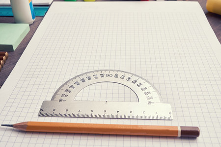 school copybook with square lined with pencil and protractor. low angle shotの写真素材