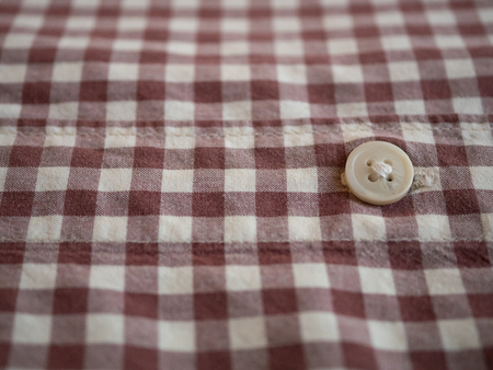 close-up of mans plaid checkered shirt with white buttonの写真素材