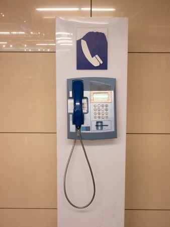 one obsolete telephone stand at airport store for those who lost their mobile smartphone. front...